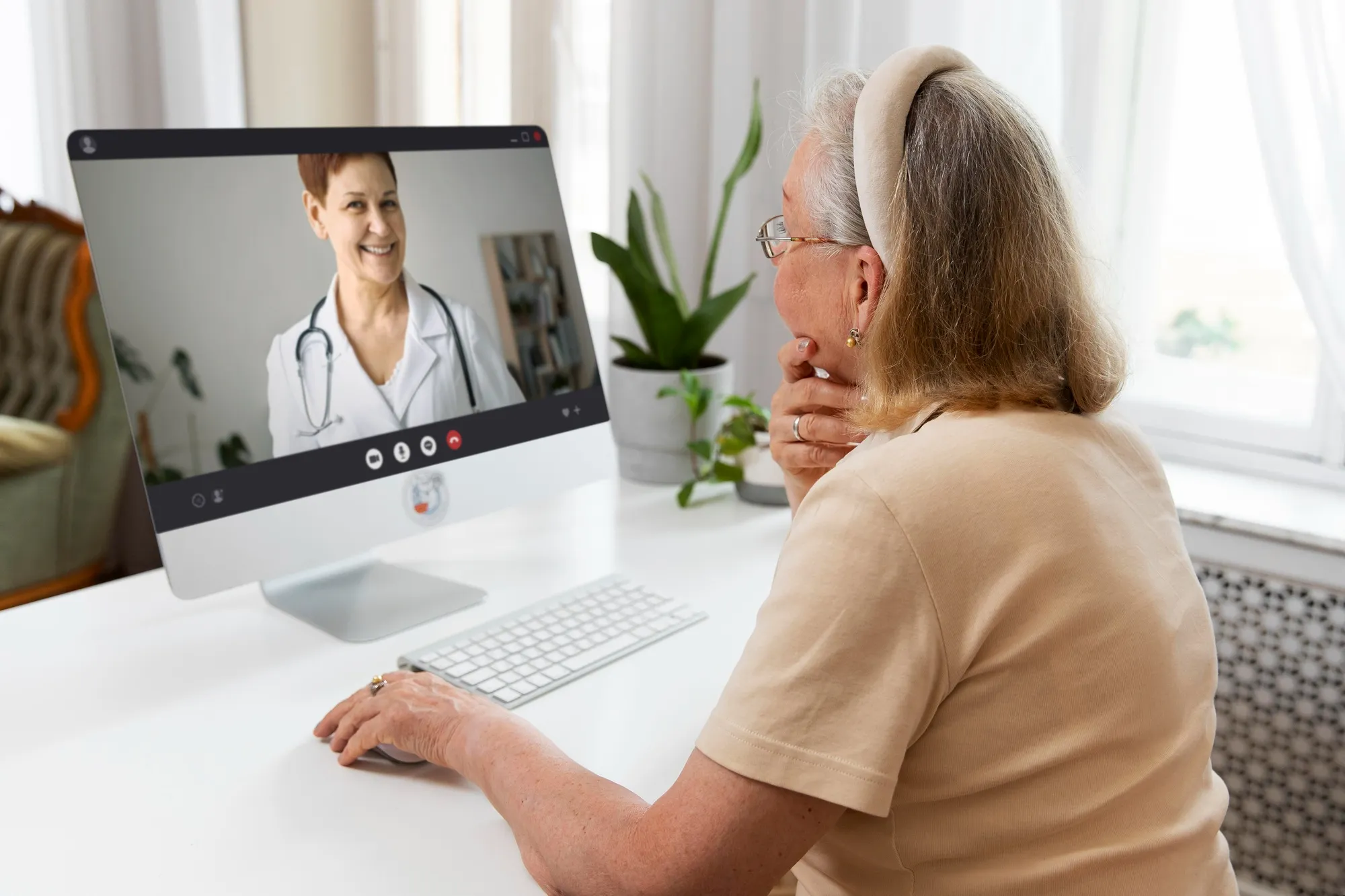 Senior patient using remote patient monitoring solutions during an online healthcare consultation from home