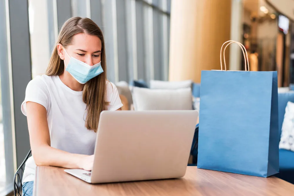 Patient using laptop for remote health monitoring solutions and telehealth healthcare services at home