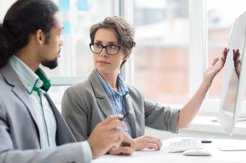 Consultants reviewing digital dashboards and workflows, showcasing data-driven insights to enhance patient care and optimize MIPS compliance and reporting