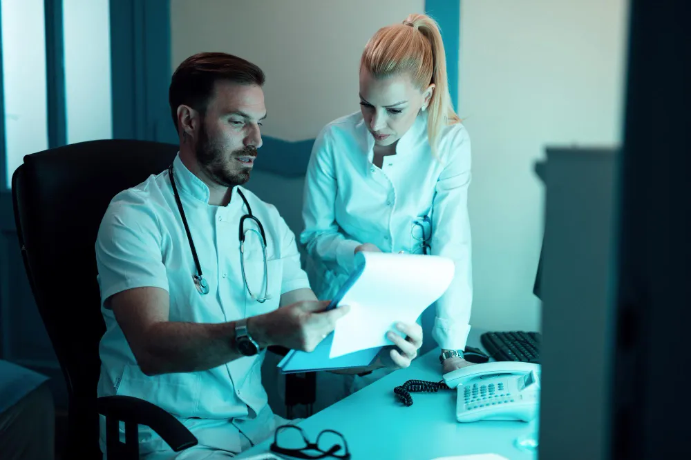 Healthcare professionals reviewing documents for Prior Authorization Approval.