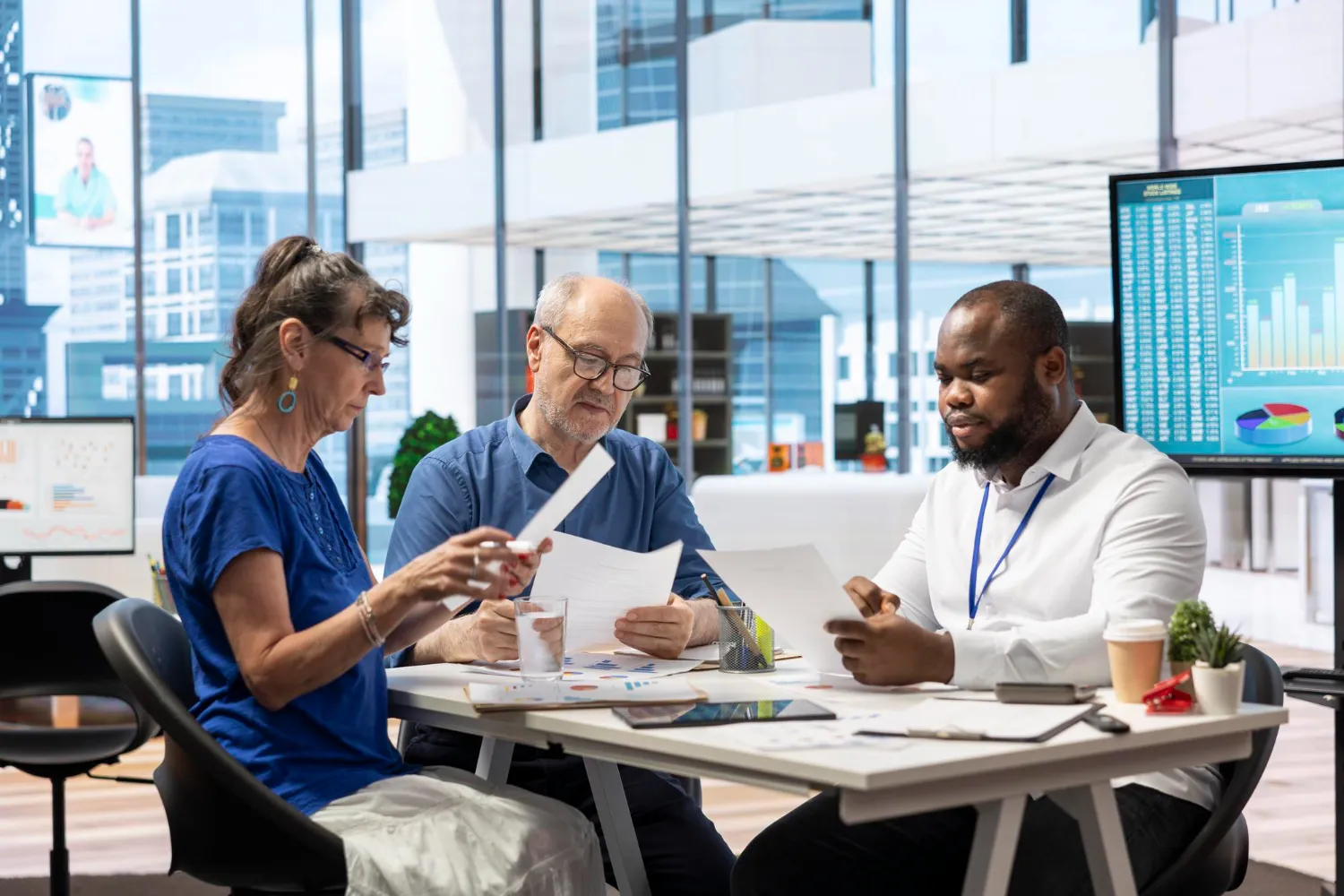 Team of professionals discussing documents and reports, highlighting collaborative decision-making within a referral system that connects multiple healthcare providers for better patient outcomes