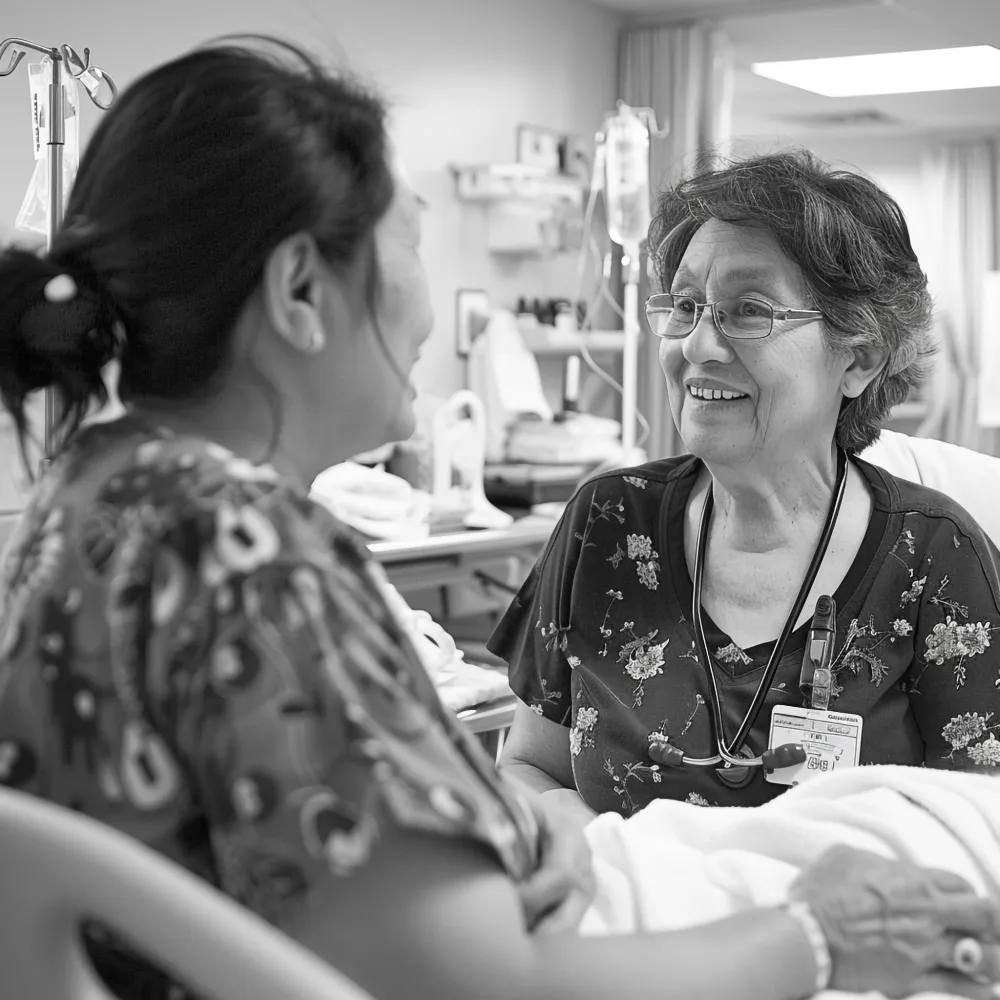 Caregiver providing emotional support to a patient in a hospital room, illustrating compassionate home health care services and ongoing support during recovery and transition phases