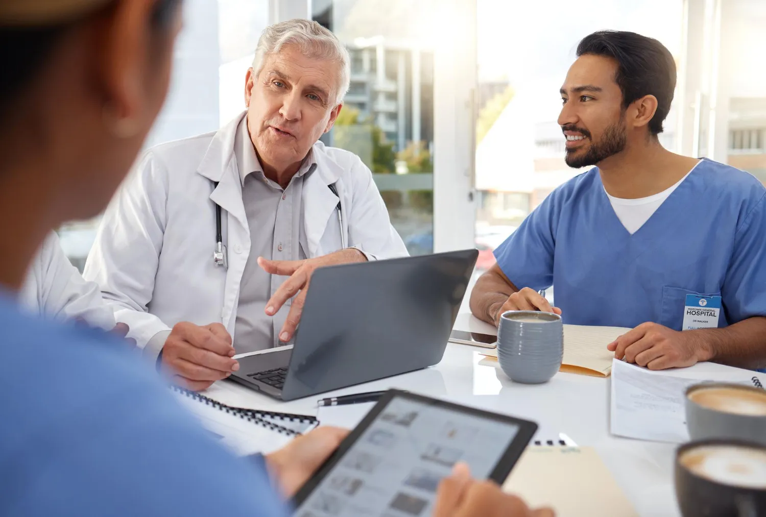 Medical professionals collaborating over patient data, representing a reliable CCM service provider delivering coordinated and data-driven care