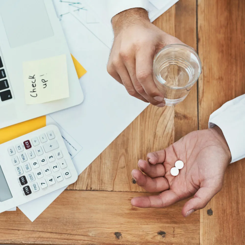 Patient taking medication at home while tracking routine tasks, illustrating Remote Patient Monitoring and improved medication adherence through daily health tracking