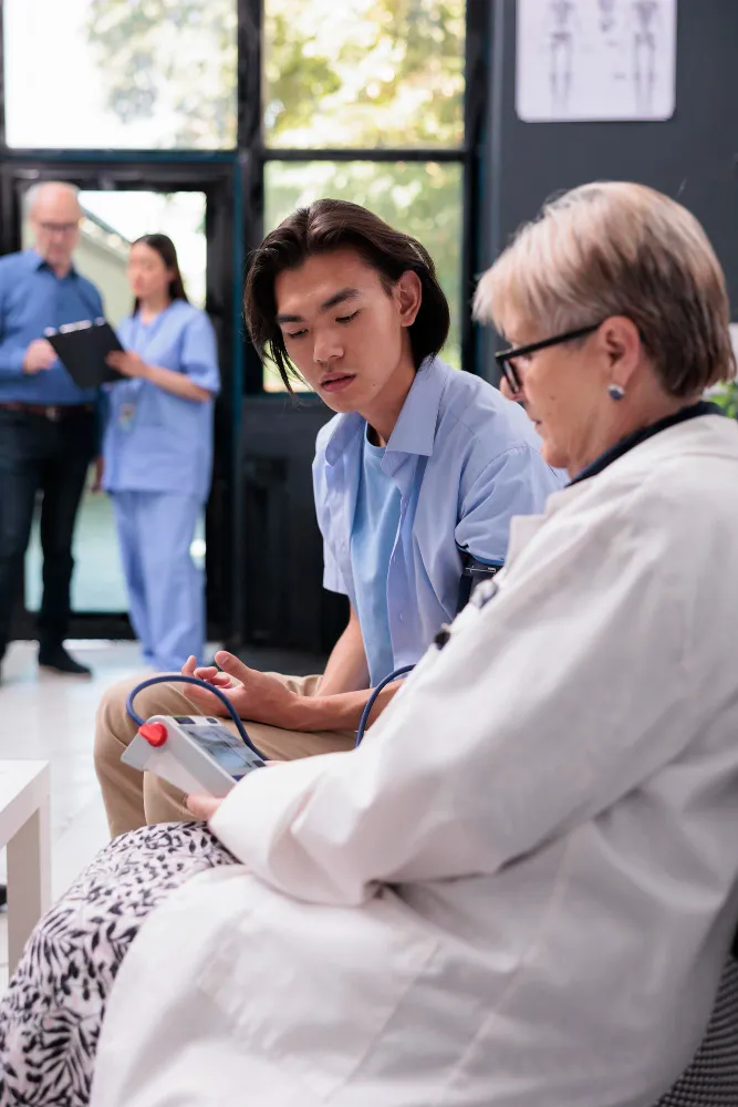 Doctor checking patient vitals and medical data for continuity of care optimization across different healthcare settings