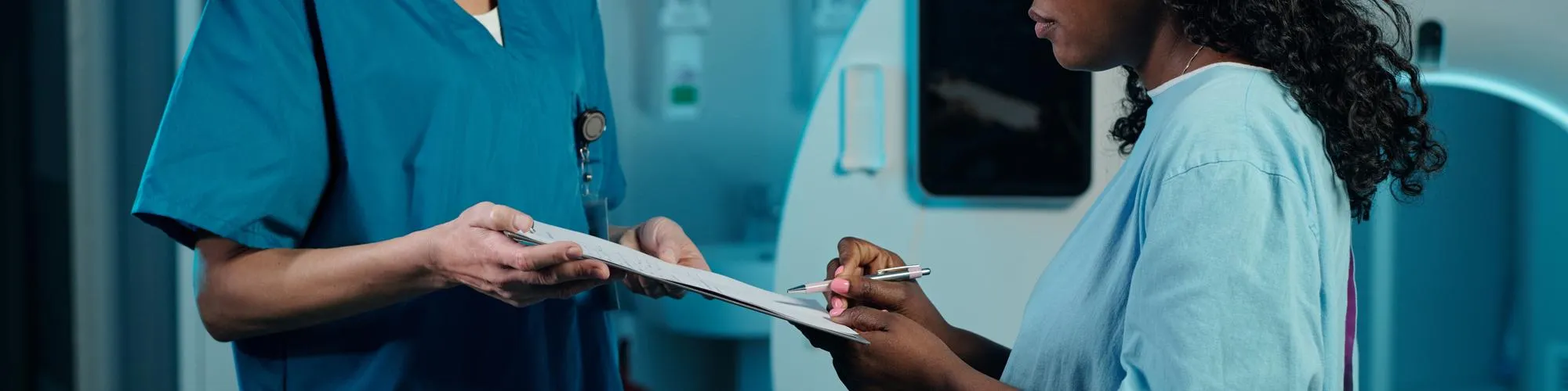 Medical staff handling patient documentation for transition care services and care coordination programs