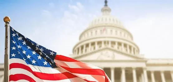 American flag waving in front of the U.S. Capitol building, representing Central Health Solutions' commitment to national healthcare standards and compliance.