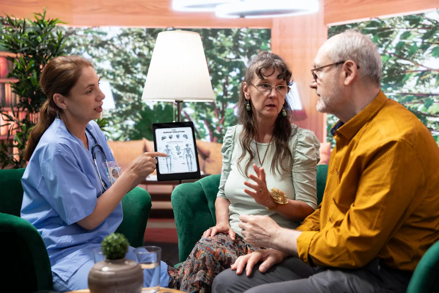 Healthcare professional explaining treatment plan to patients to support continuity of care and coordinated transitional care management