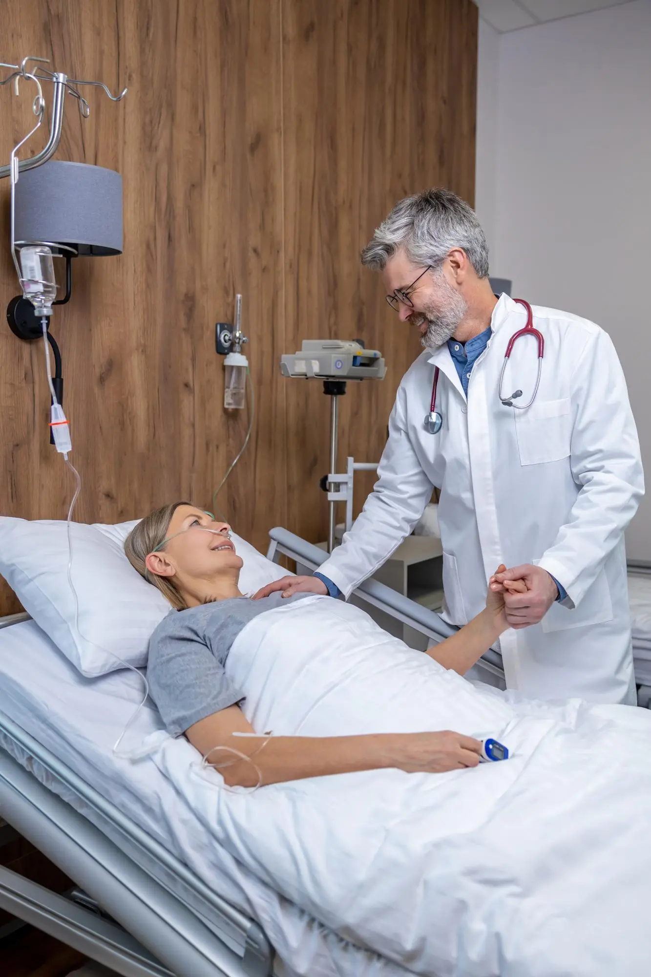 Physician monitoring a hospitalized patient's recovery, representing Central Health Solutions' remote patient monitoring and digital health tracking solutions