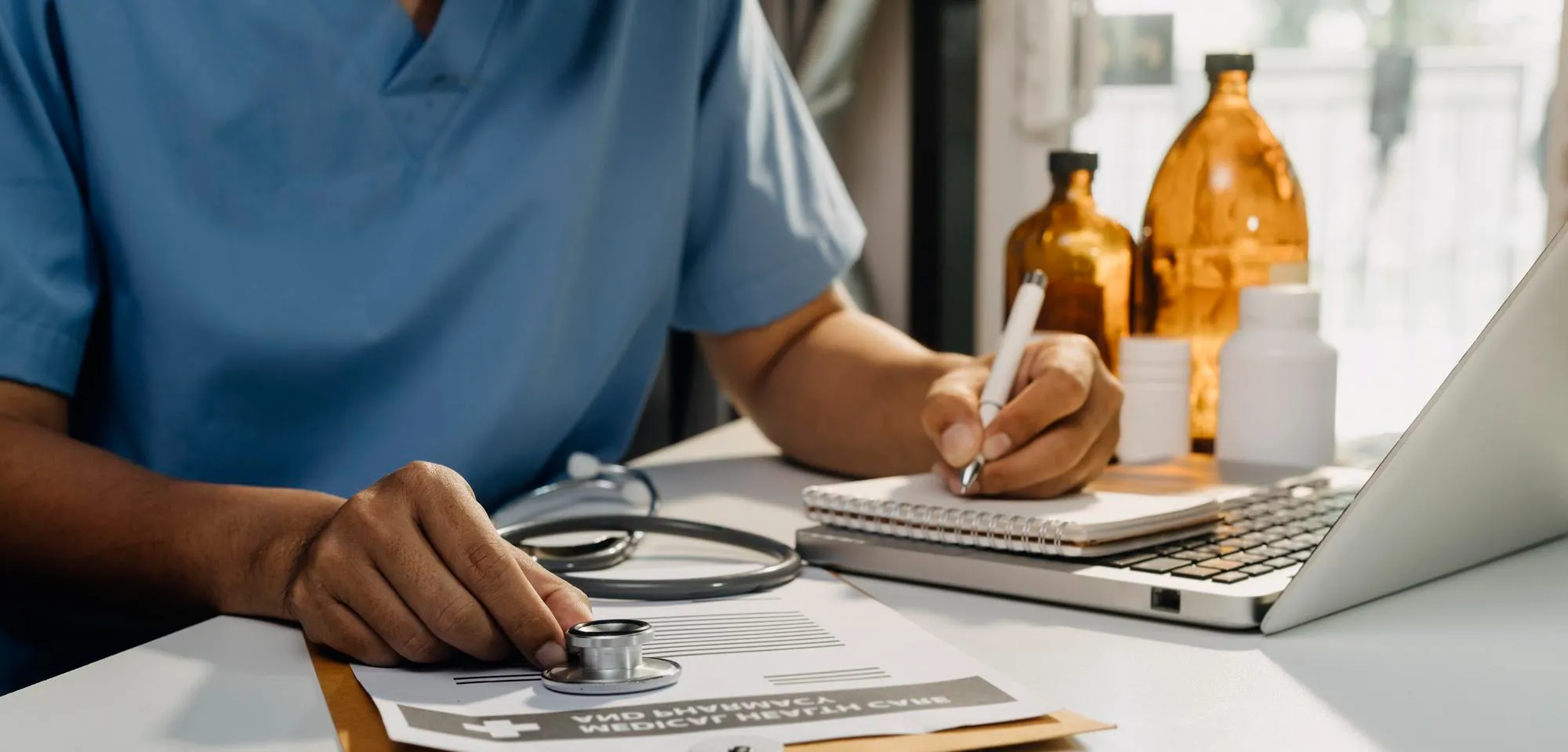 Physician managing patient data digitally for remote chronic disease management and continuous care monitoring