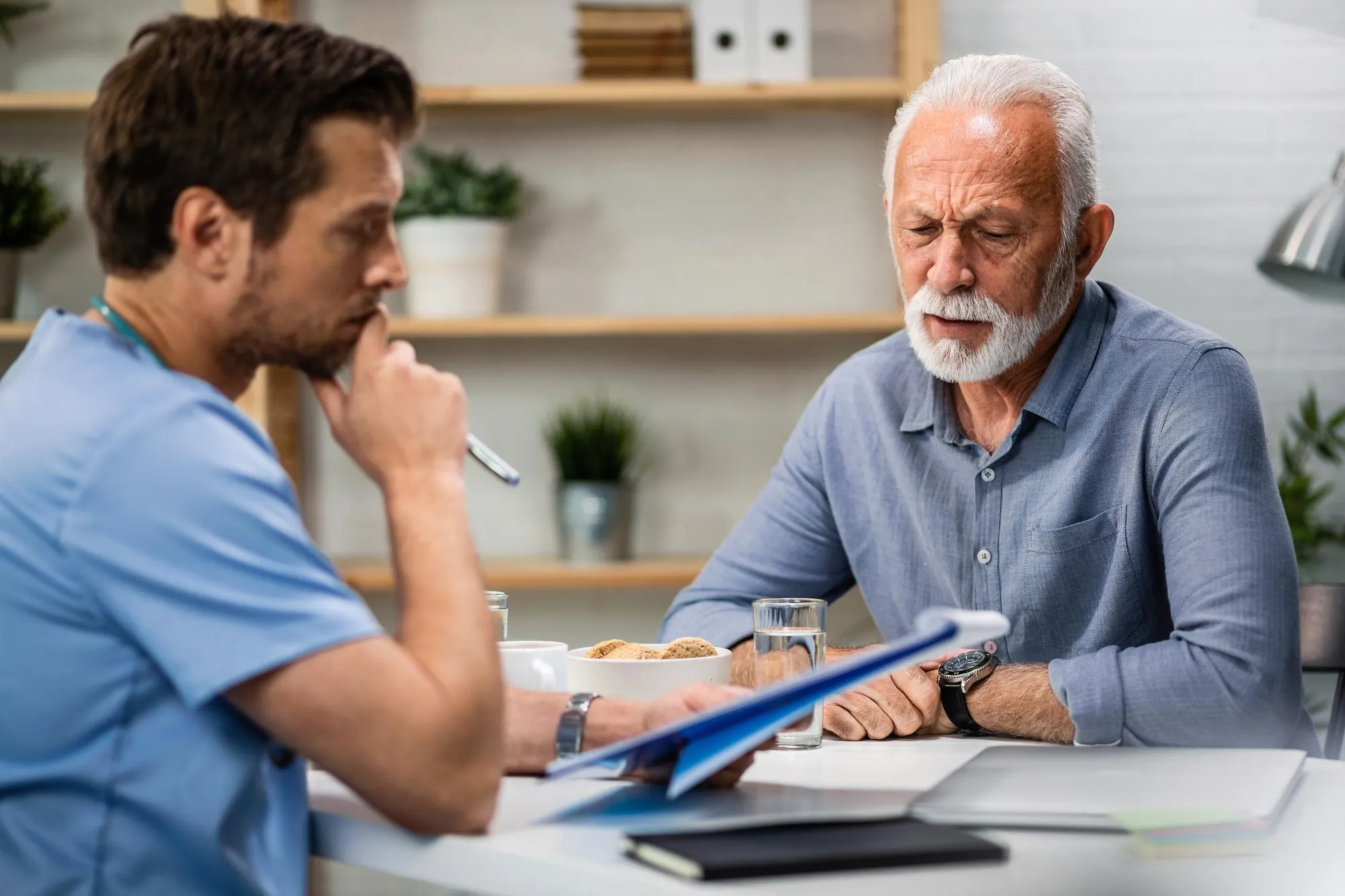 Physician discussing treatment plans with an elderly patient, showcasing Medicare Principal Care Management and ongoing support for individuals with chronic conditions