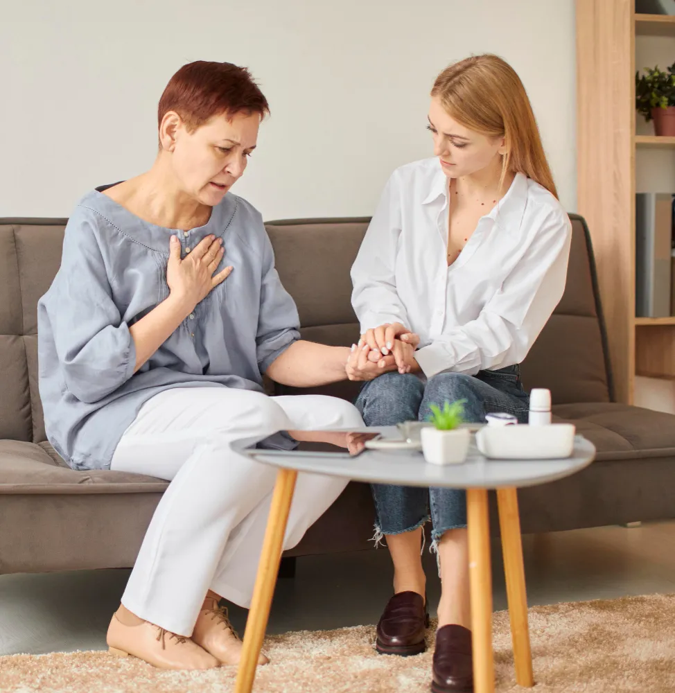 Health monitoring solutions with caregiver checking pulse and supporting senior patient at home