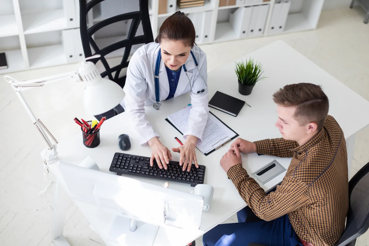 Healthcare provider discussing Chronic Condition Care Management Services with a patient, creating a personalized care plan and coordinating ongoing support for chronic disease management.