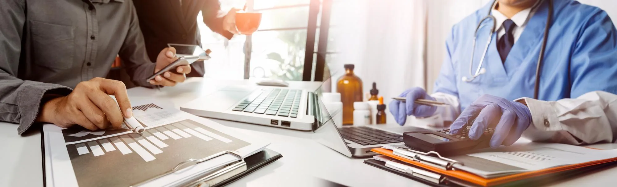 Healthcare professionals reviewing financial reports and billing data for Revenue Cycle Management, optimizing medical billing, claims processing, reimbursement, and healthcare revenue performance.