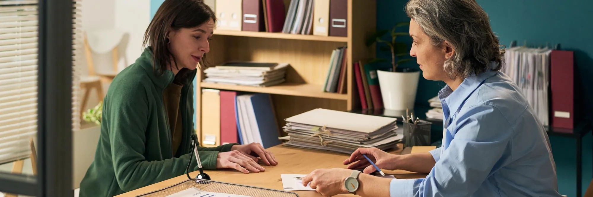 Healthcare professional discussing transition care planning with a patient, representing Transition Care Management services and coordinated post-discharge care.