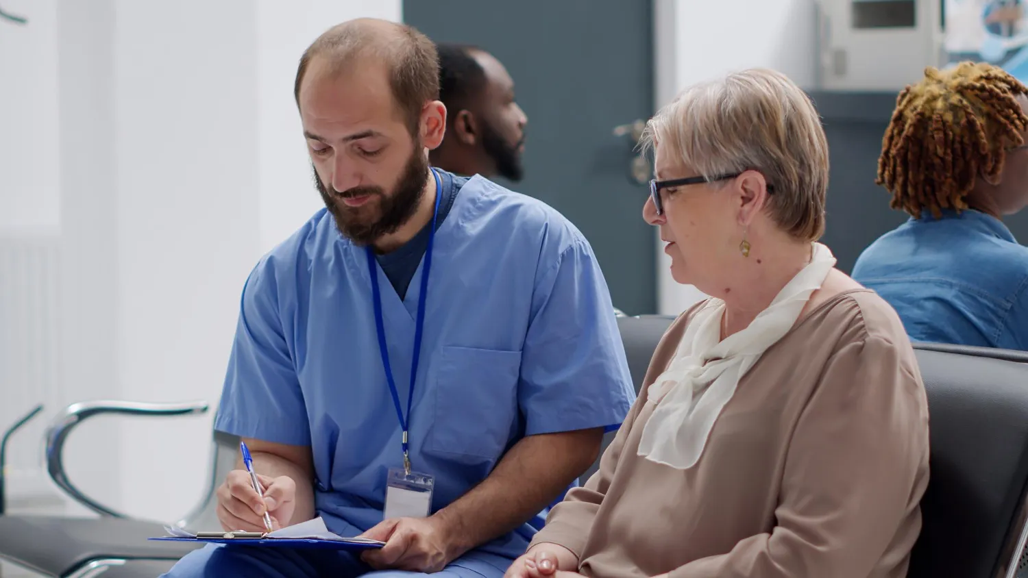Healthcare professional discussing follow-up care with a patient through a transition care management solution.