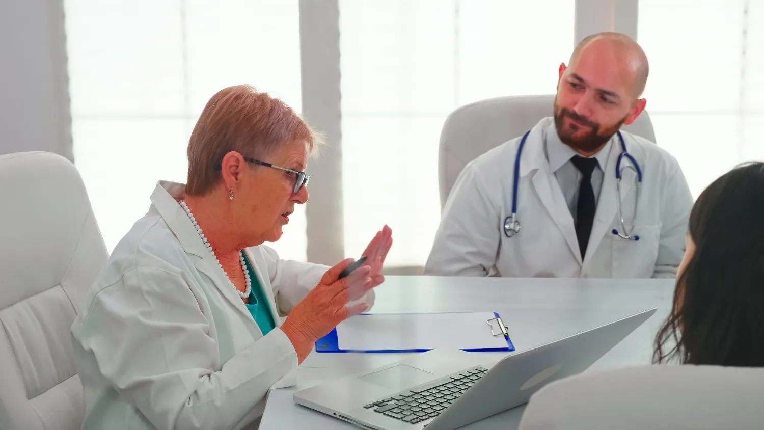 Physician consulting with a patient during an appointment, highlighting healthcare referral management that supports timely specialist referrals and coordinated patient care.
