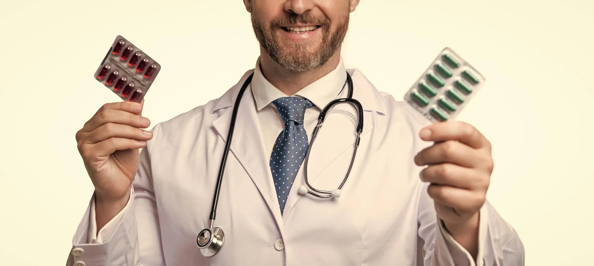 A healthcare professional holding different medication blister packs, highlighting medication management solutions to support medication safety and treatment planning.
