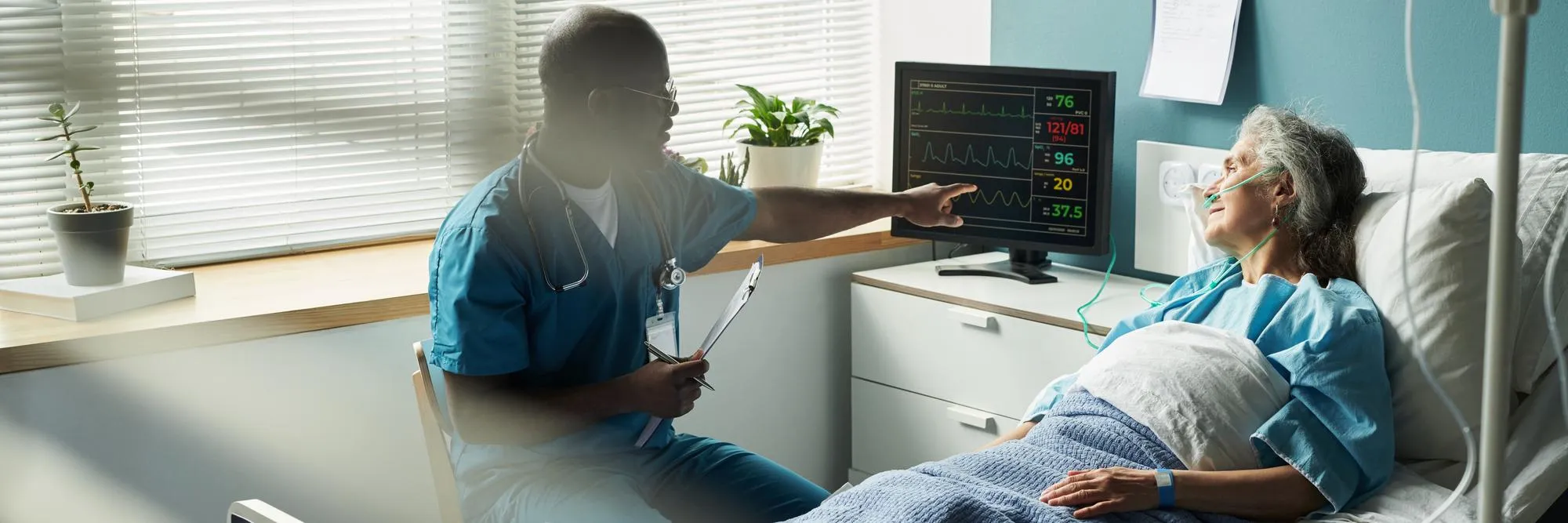 Healthcare professional monitoring an elderly patient’s vital signs in a hospital room, illustrating CCM and RPM services for ongoing patient care and health monitoring.