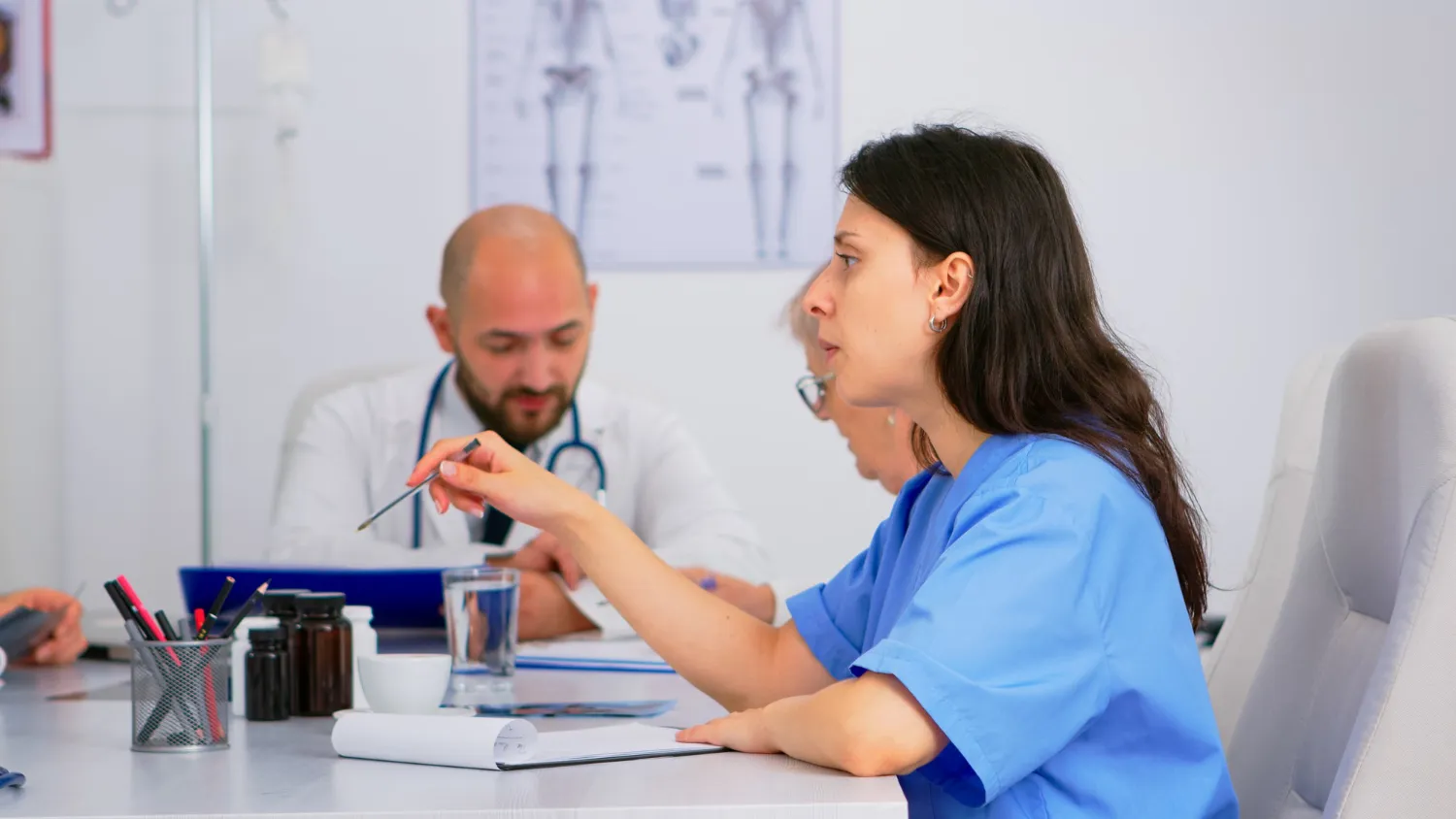 Healthcare professionals discussing medication management and treatment plans, representing medication management services for healthcare providers.