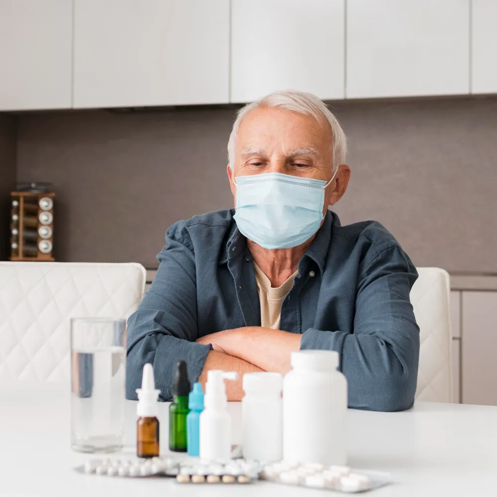 An older adult reviewing medications and prescription bottles, illustrating common medication management challenges and the importance of safe medication use.